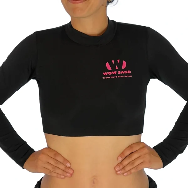 Black crop top with long sleeves by WOW Sand, ideal for sand volleyball and outdoor sports.