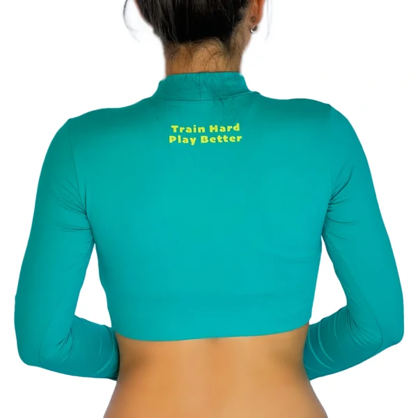 WOW Sand’s iris blue long sleeve crop top for comfortable sand volleyball play.